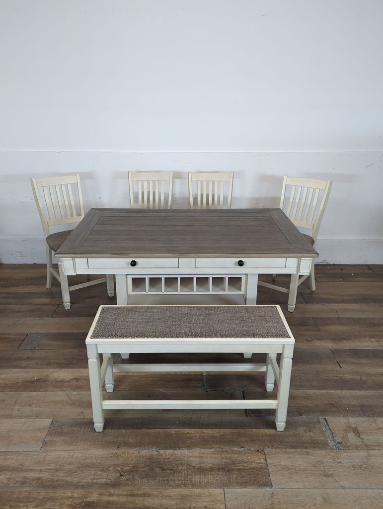 1. Ashley Furniture dining set with a rectangular table, four chairs, and a bench on wood flooring.