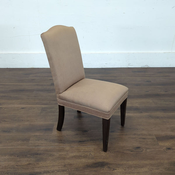 1. Reperch dining chair with taupe upholstery and dark wood legs, angled view on wood floor.