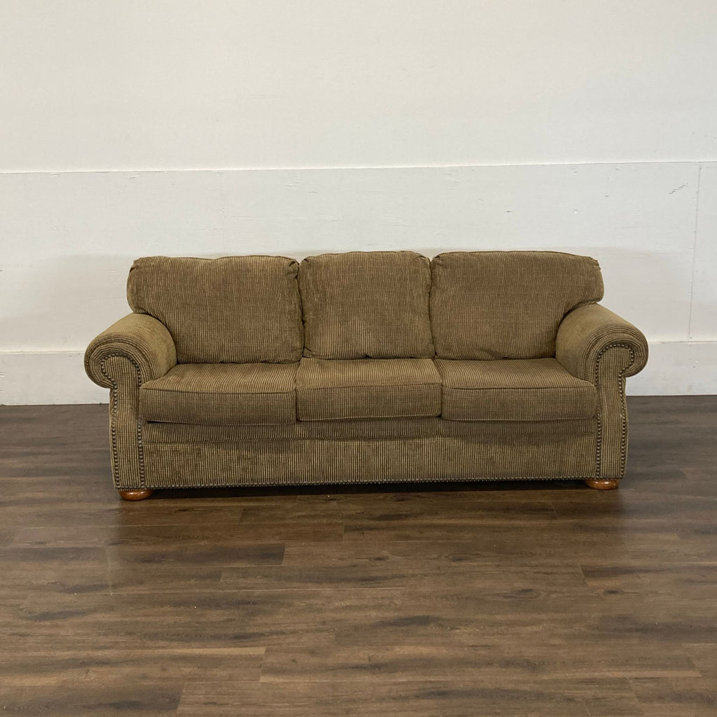 2. Reperch 3-seat brown corduroy sofa with rolled arms, shown against a plain white wall on wood flooring.