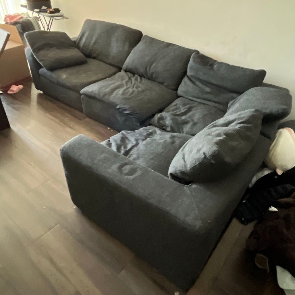 2. Dark gray sectional sofa from Restoration Hardware with supportive cushions, offering plenty of comfortable seating.