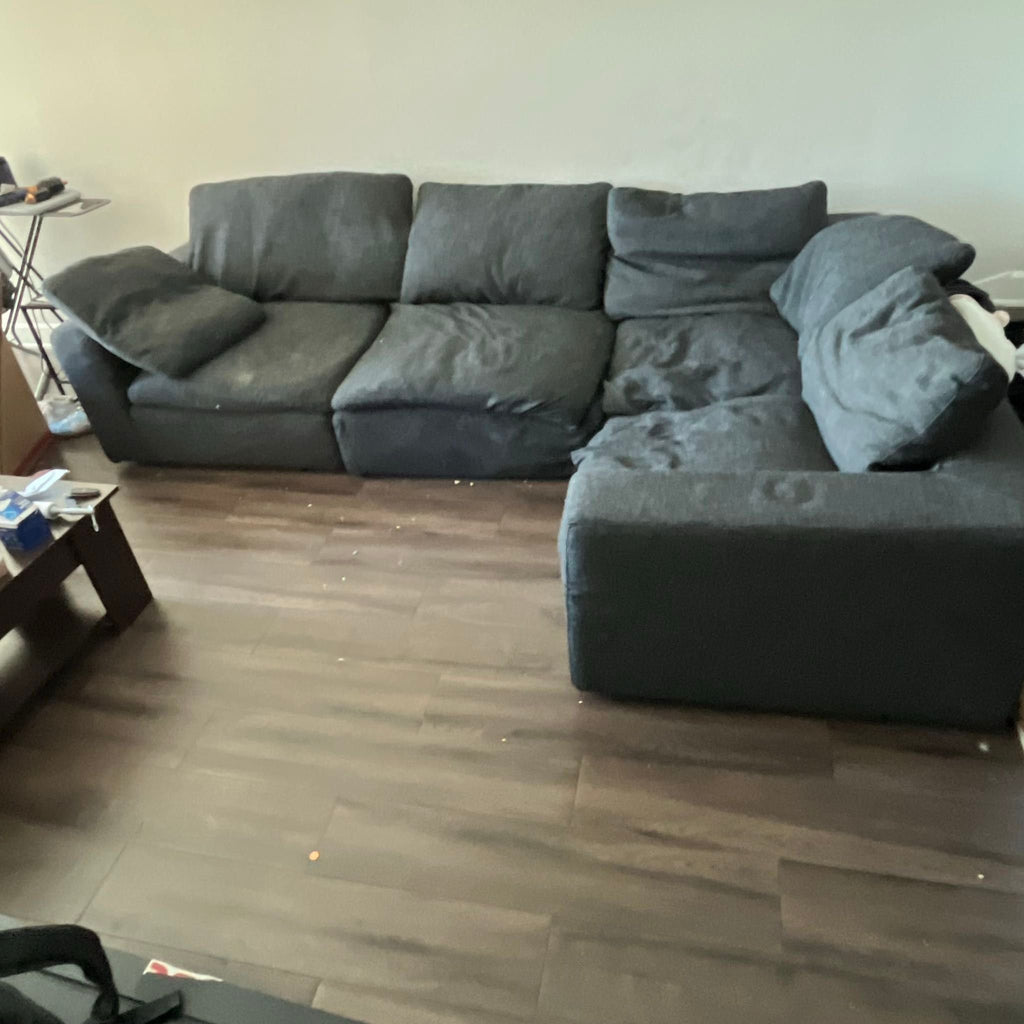 1. Spacious L-shaped Restoration Hardware sectional in dark gray fabric, showing minor wear, ideal for large living rooms.