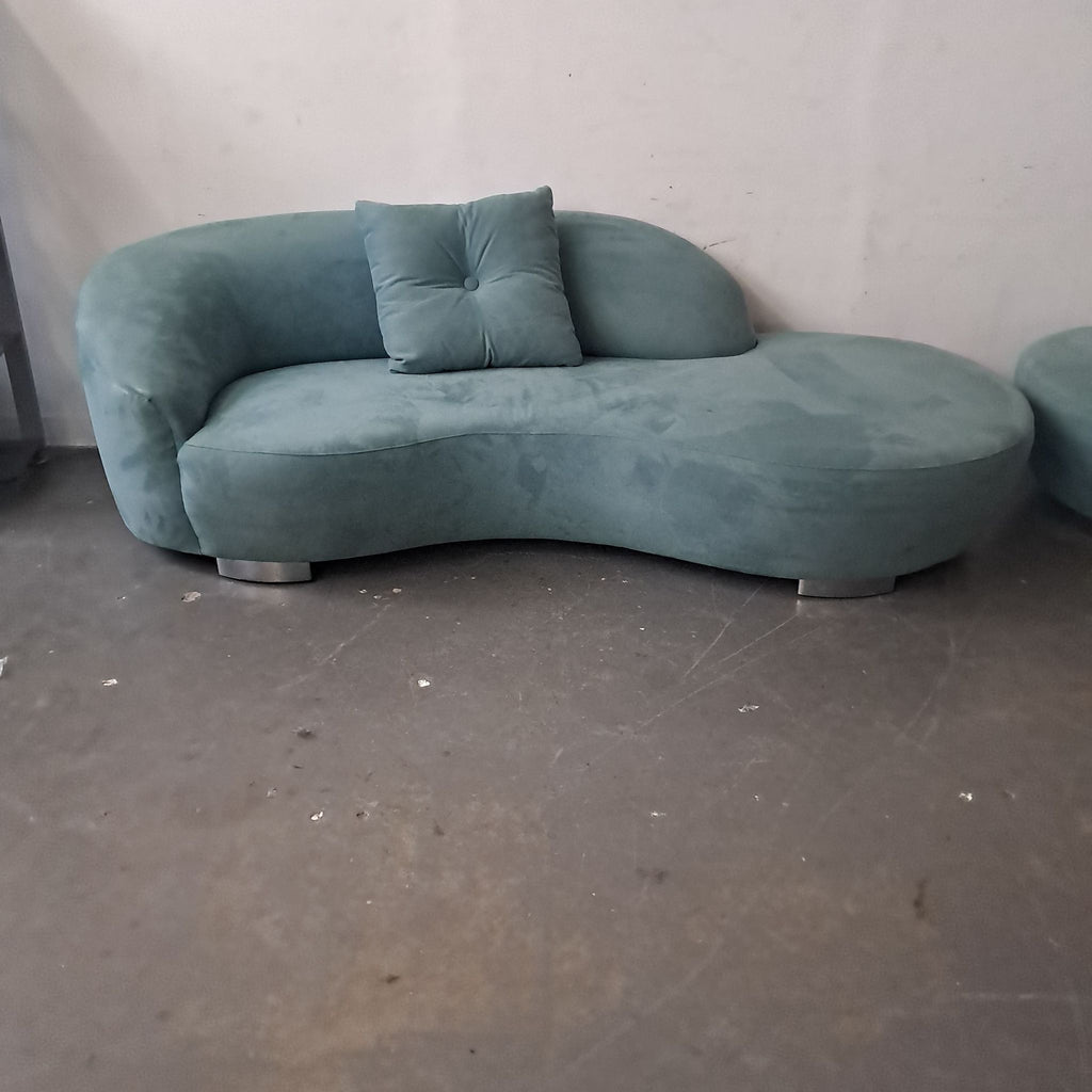 3. Detailed view of a Lazar Industries teal sectional with a single centered pillow and modern curved design.