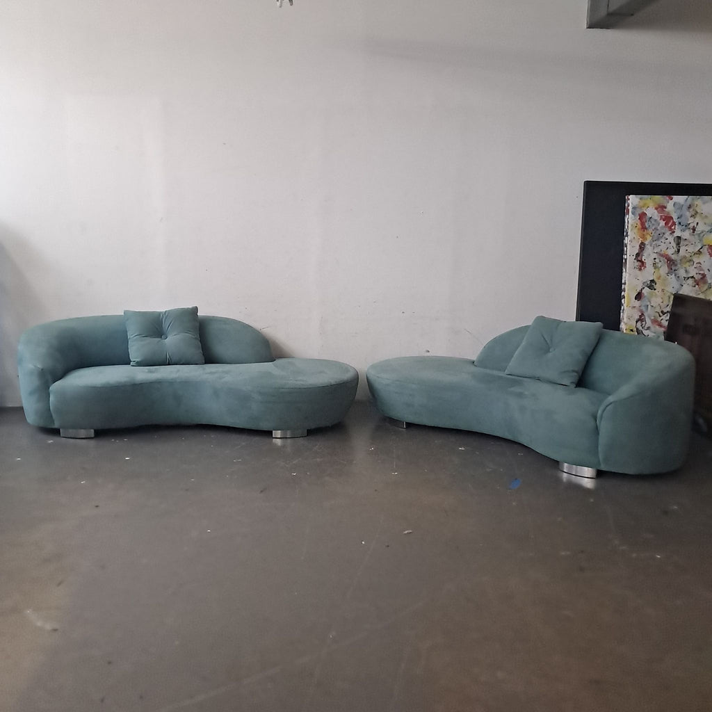 1. Two curved teal sectional sofas by Lazar Industries with matching pillows and metal feet in an industrial room.