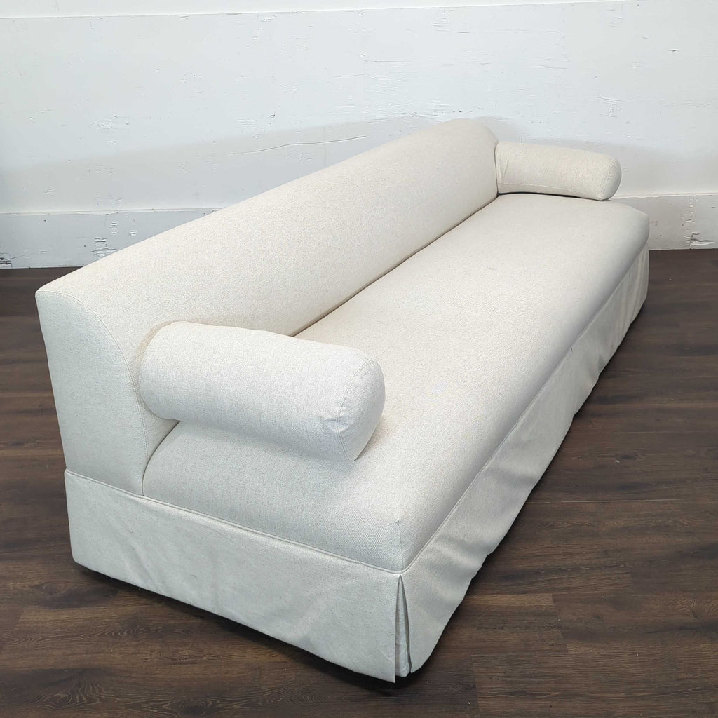 2. Angled view showing the modern shape and textured beige upholstery of the Shoppe Amber Interiors 3-seater.