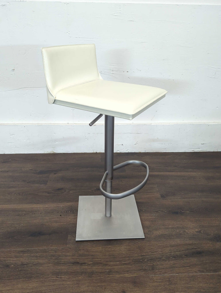 1. Modern white leather swivel stool with gas lift, square base, and footrest, ideal for bar or counter seating.