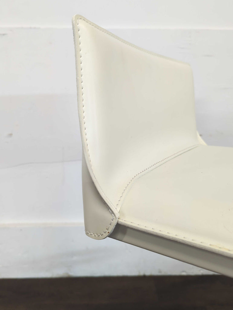 Hand sewn stain-resistant leather. Features a gas piston lift and36 degree swivel. Height adjustable for counters and bars.