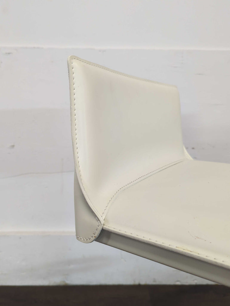 Hand sewn stain-resistant leather. Features a gas piston lift and36 degree swivel. Height adjustable for counters and bars.