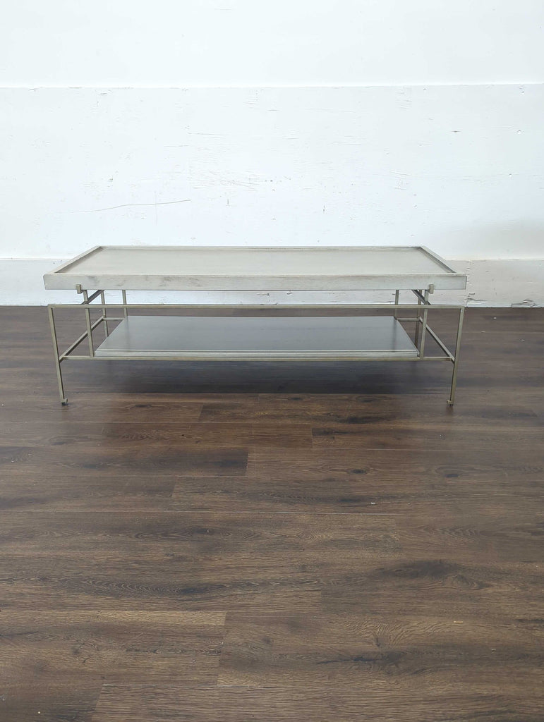 Rectangular Reperch coffee table with light wood top and metal frame, shown against a white wall on wood floor.  