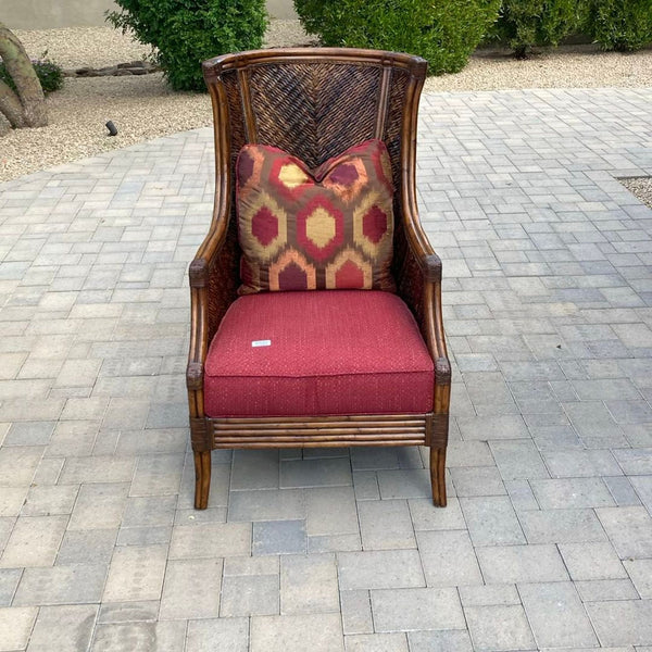 Lexington Furniture lounge chair with wicker frame, red cushion, and patterned pillow for stylish relaxation.