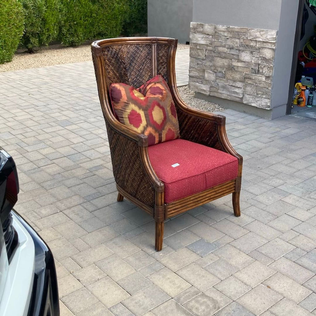Wicker lounge chair by Lexington Furniture featuring a high back, red seat cushion, and accent pillow.