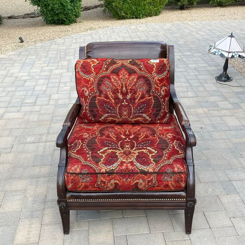 Paul Schatz lounge chair with a dark wood frame and plush red floral cushions, ideal for stylish relaxation.