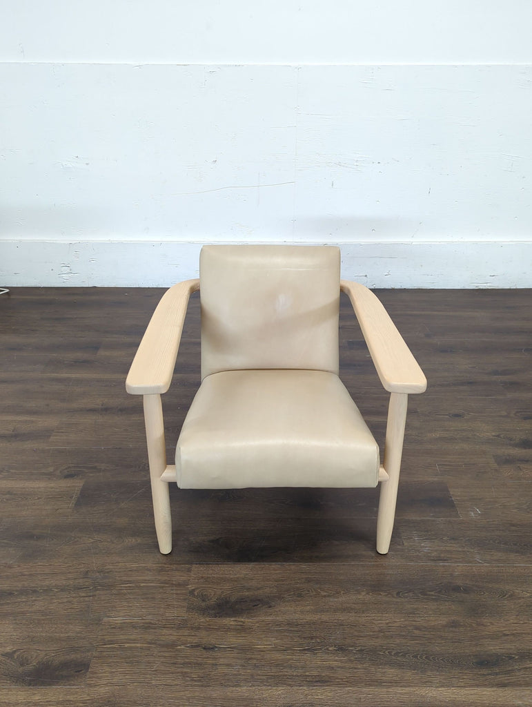 3. Front view of a Four Hands lounge chair featuring tan leather seat and light wood frame, category: Lounge.