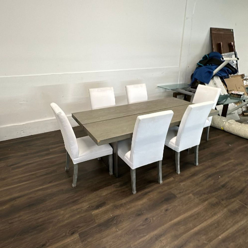 Set of cream-colored linen dining chairs by Restoration Hardware, styled in a dining room setting.
