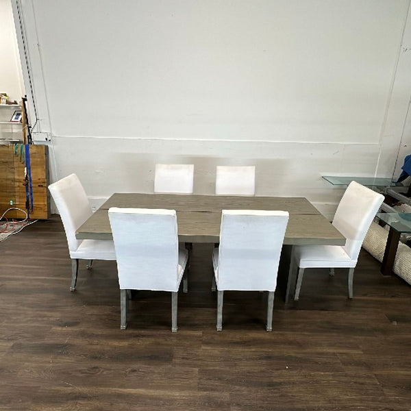 Cream-colored linen dining chairs from Restoration Hardware, shown as part of a modern dining set.