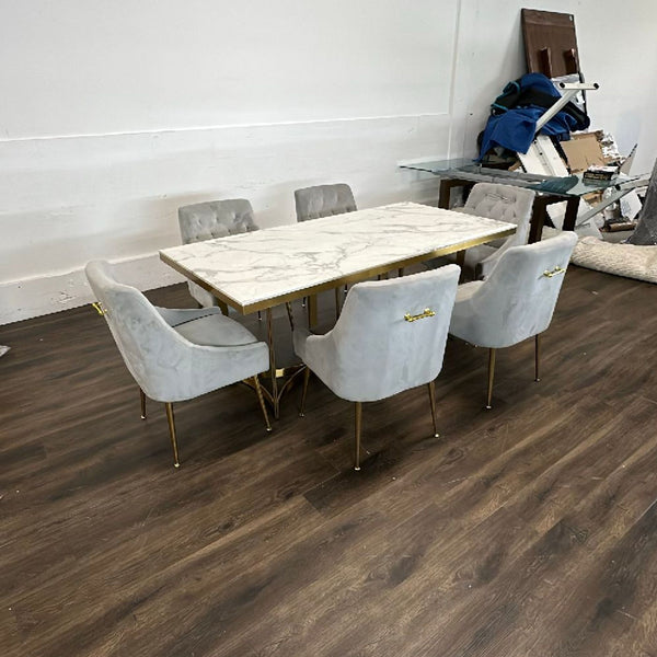 Wayfair 7-piece dining set with marble-look table, gold base, and six gray velvet, gold-accented chairs.  