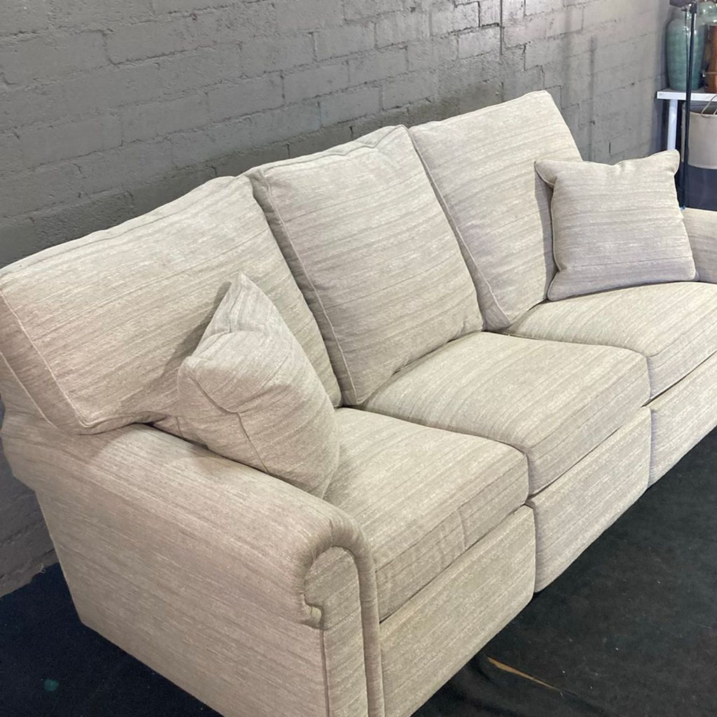 Beige fabric Stickley sofa for 3, includes two pillows, thick cushions, and rolled arms; power cord missing.