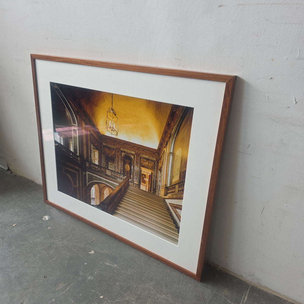 Detailed photograph art print shows a beautifully ornate staircase with a wooden frame and white mat, classic décor.  