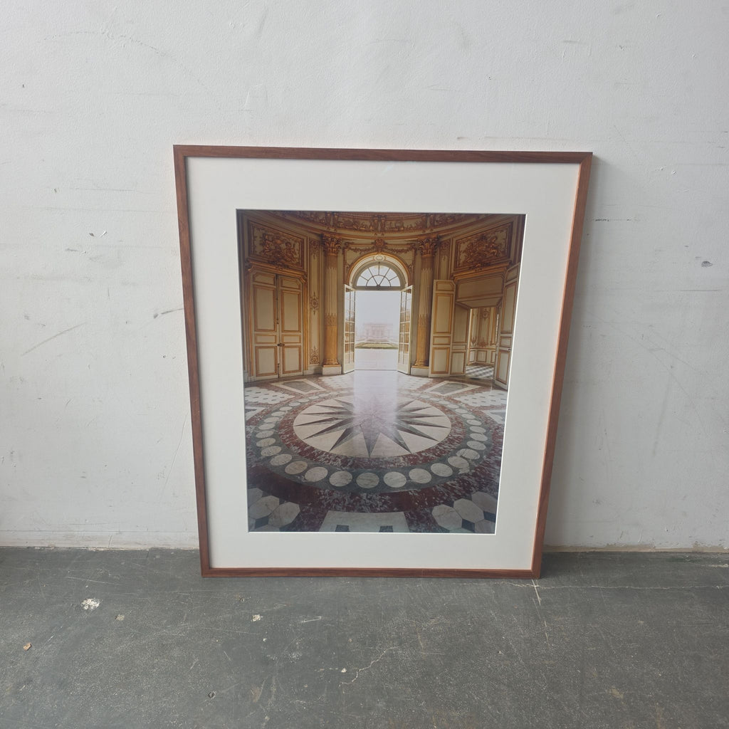 Framed print of ornate palace interior with elegant doors and patterned floor, adding sophistication to any room.  