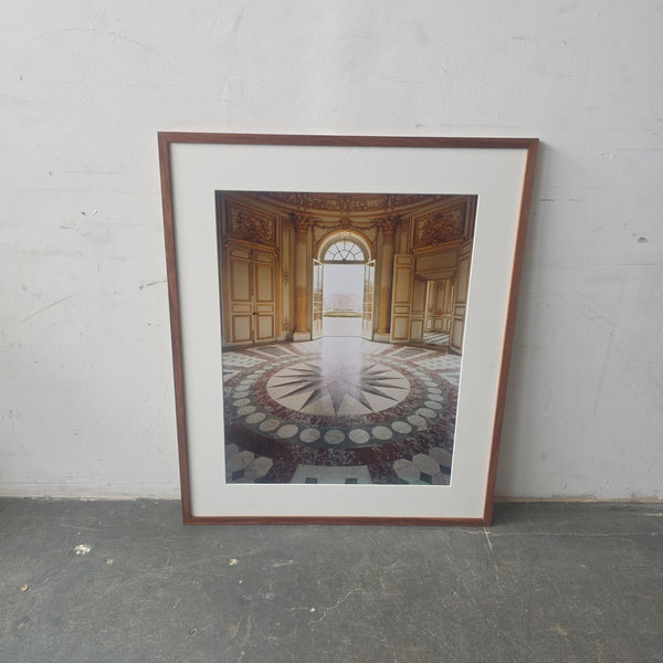 Framed print of ornate palace interior with elegant doors and patterned floor, adding sophistication to any room.  