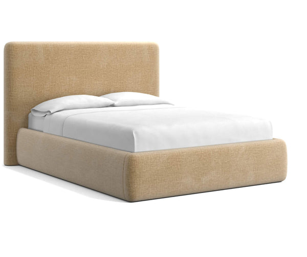 Upholstered bed frame with seamless, plush padding and classic curves, shown in a cozy bedroom setting.