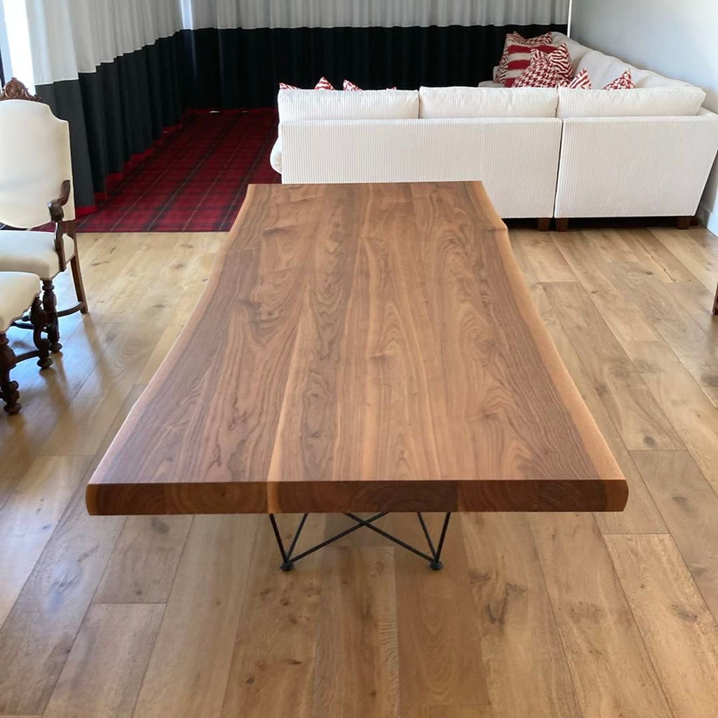 2. Modern dining table by Cattelan Italia, featuring a unique wood grain top and sturdy metal legs.