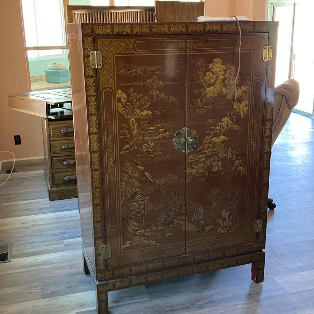 Drexel Heritage cabinet with gold Asian-inspired designs, double doors, and a decorative clasp, ideal for statement decor.