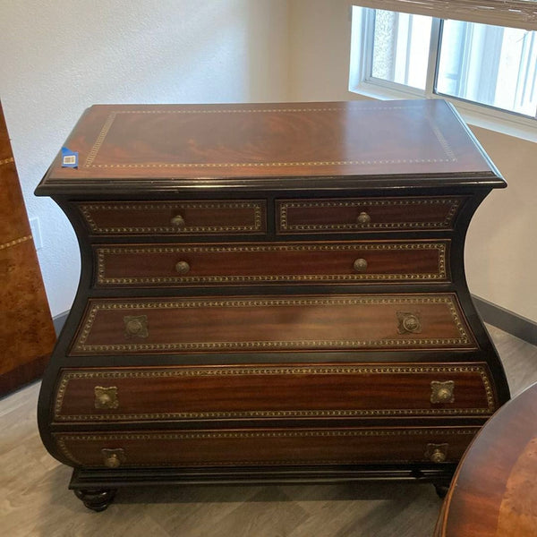 Thomasville mahogany dresser with curved sides, four drawers, and brass handles, offering classic elegance.