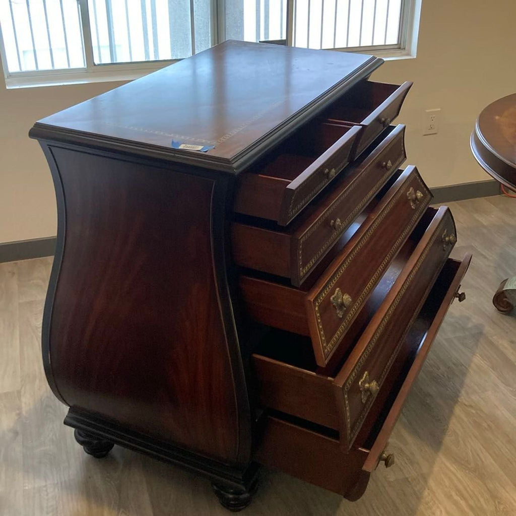 Vintage-style Thomasville dresser featuring a rich mahogany finish, decorative trim, and spacious storage drawers.