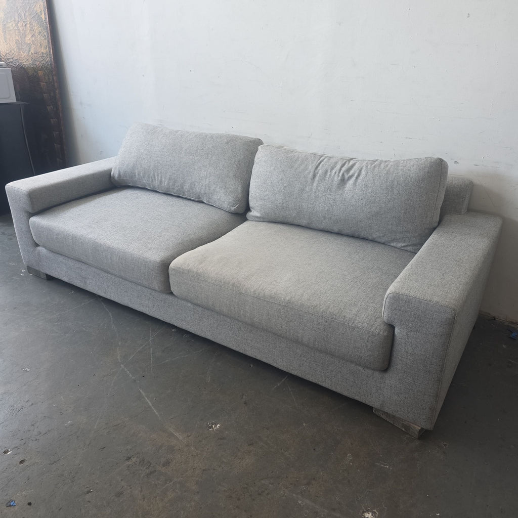Modern Ben Soleimani 3-seater sofa in neutral gray fabric; clean lines and plush cushions suitable for any décor.