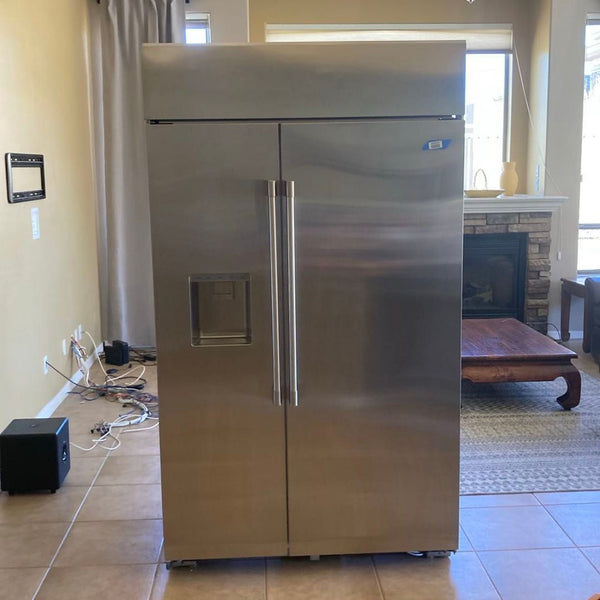 GE Monogram side-by-side refrigerator with stainless steel finish and external ice dispenser, in great condition.