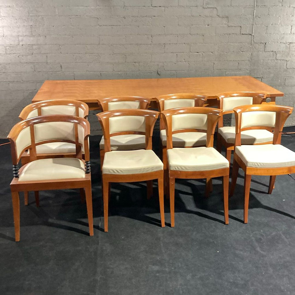 Giorgetti dining set featuring a large cherry wood table and eight matching cream-seat chairs.