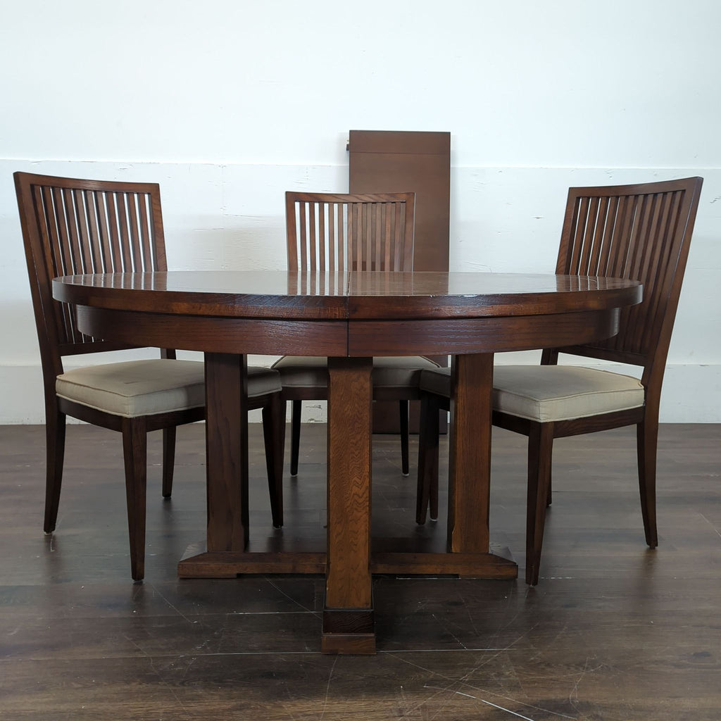 2. Contemporary Crate and Barrel dining set with a round table and matching chairs on a stylish rug.
