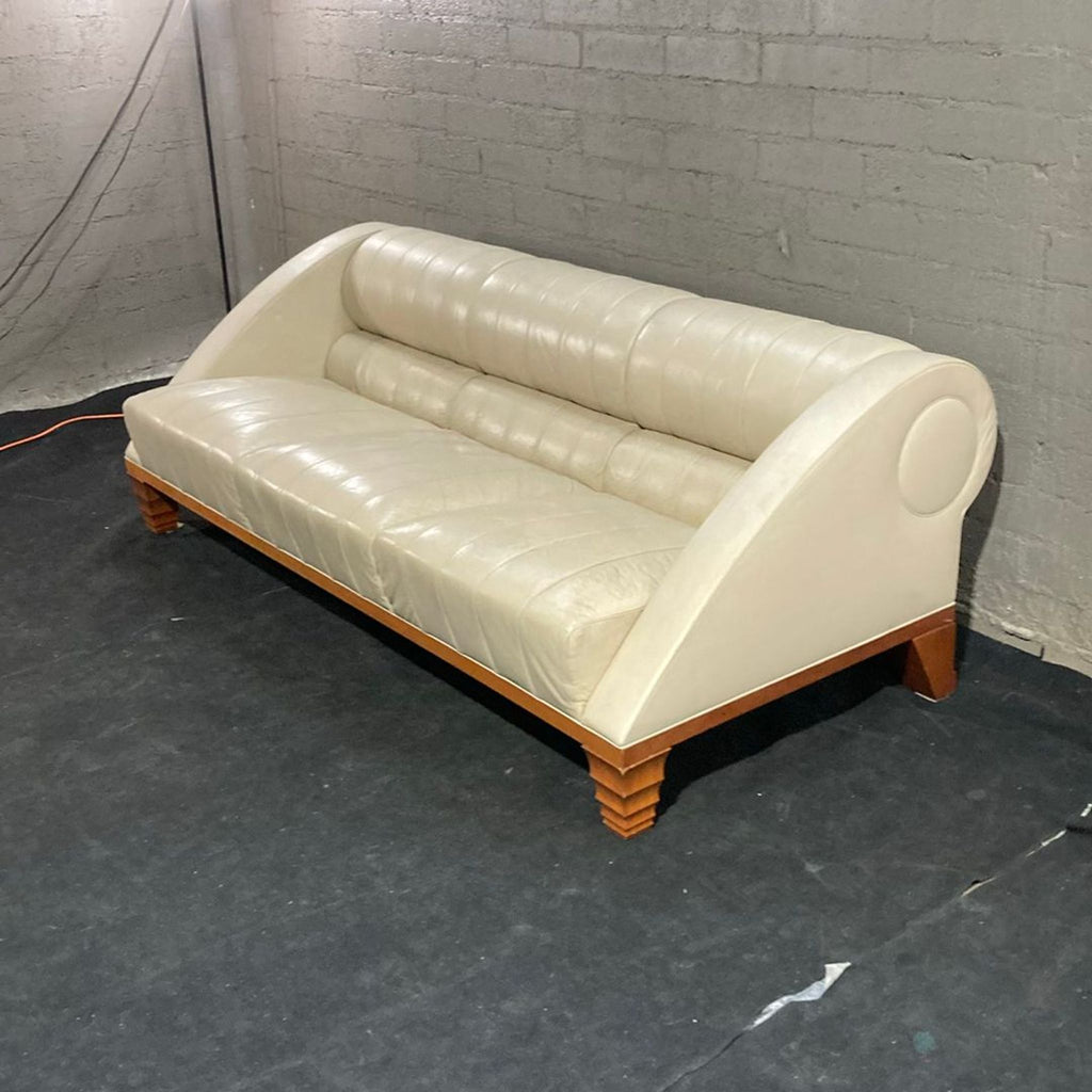 Modern black leather Giorgetti sofa with deep cushions, wooden base, and stylish armrests for comfort.  