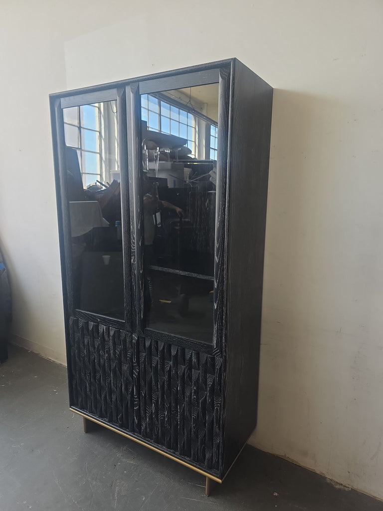 Modern black entertainment center by Luxe Showcase, featuring glass doors above and wood-detailed lower panels.  
