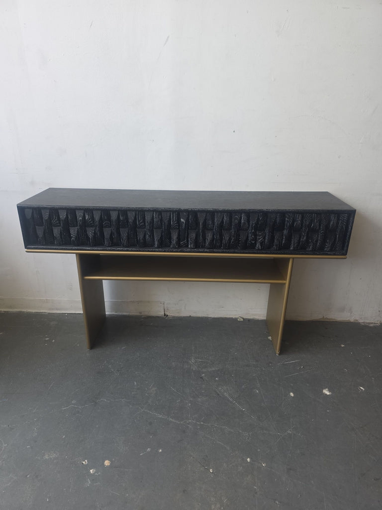 Modern Luxe side and console table with black textured drawer front and gold sides, offering extra shelf storage.