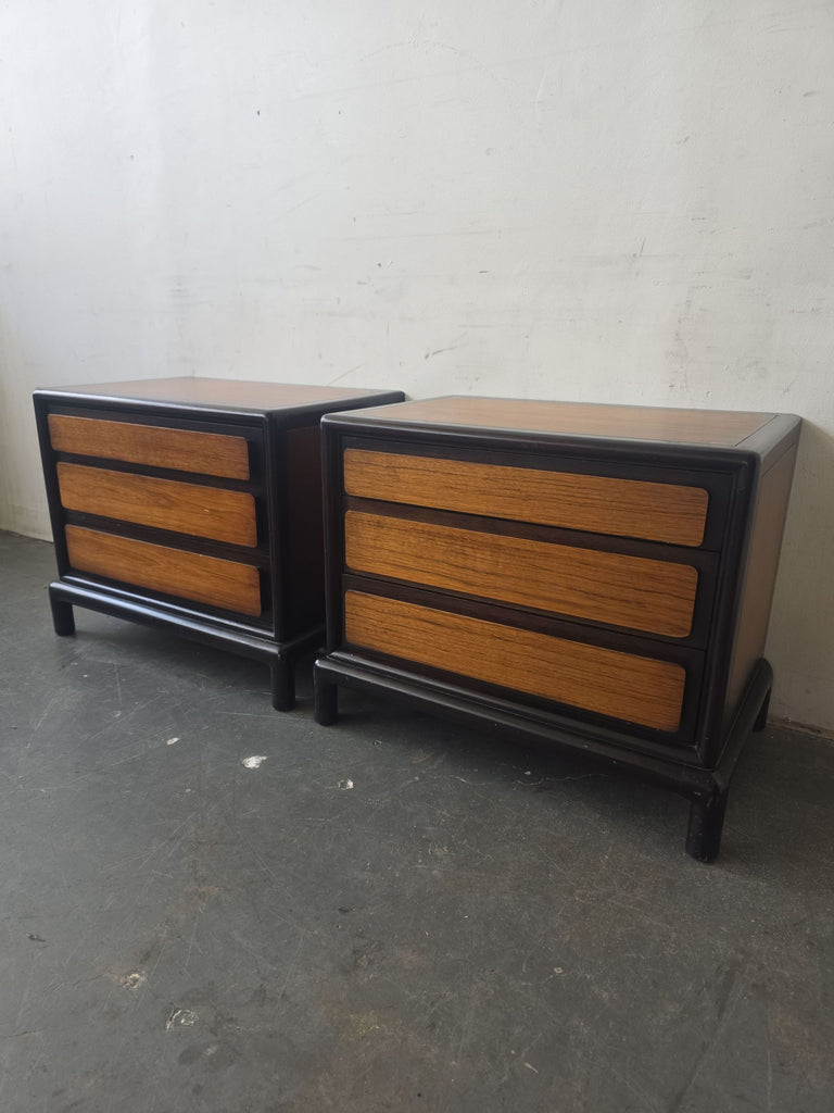 Set of two mid-century modern end tables by John Stuart, featuring a unique wood finish, black framing, and ample storage.