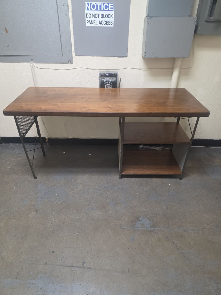 Vitra desk with a spacious wooden top, sturdy metal frame, and two right-side open shelves for storage.  
