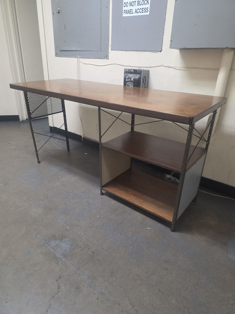 Modern Vitra desk featuring smooth wood surface, durable metal legs, and dual open shelves for organization.  