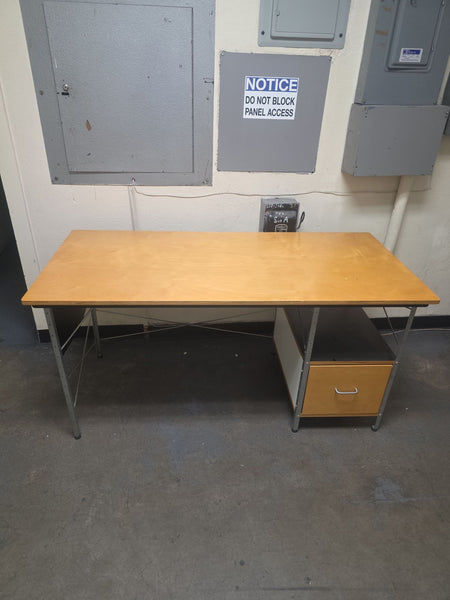 1. Mid-century Herman Miller desk with a wooden top, metal frame, and one built-in drawer and shelf.