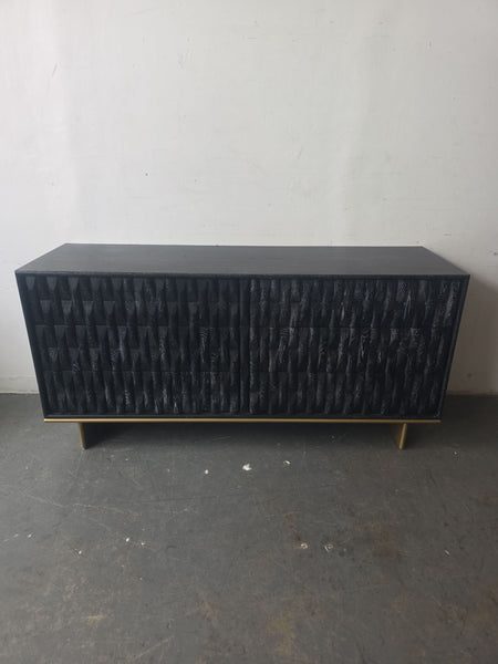 Luxe black dresser with a textured front, gold base, and spacious storage for modern bedrooms or living rooms.  