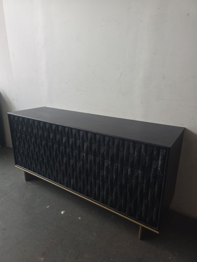 Black Luxe dresser with gold accent base and unique textured drawers, perfect for stylish storage.  