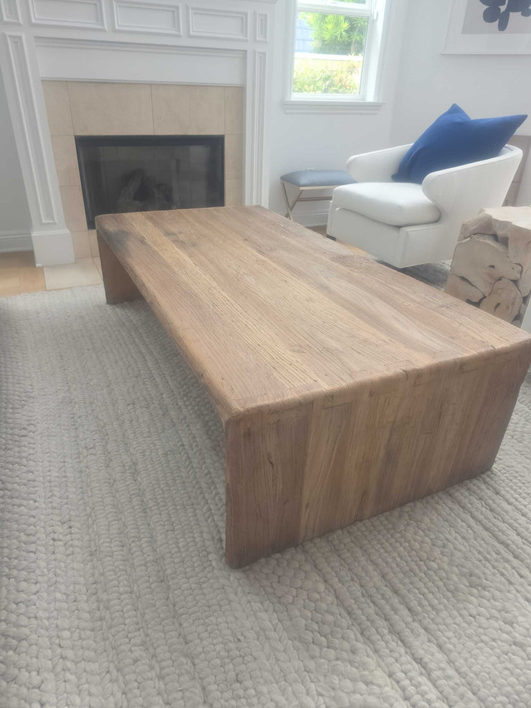Rectangular coffee table in natural wood, durable design, ideal for living room setups and easy to maintain.