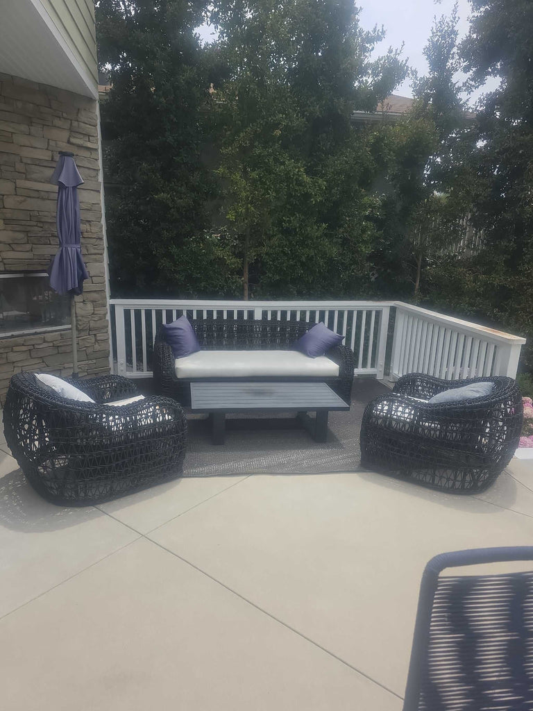 Complete outdoor wicker set: sofa, two chairs, coffee table, comfy cushions, and pillows, all in great shape.