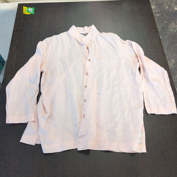 1. Pale pink women's button-up shirt with long sleeves by Go Silk, laid out flat on a dark table.