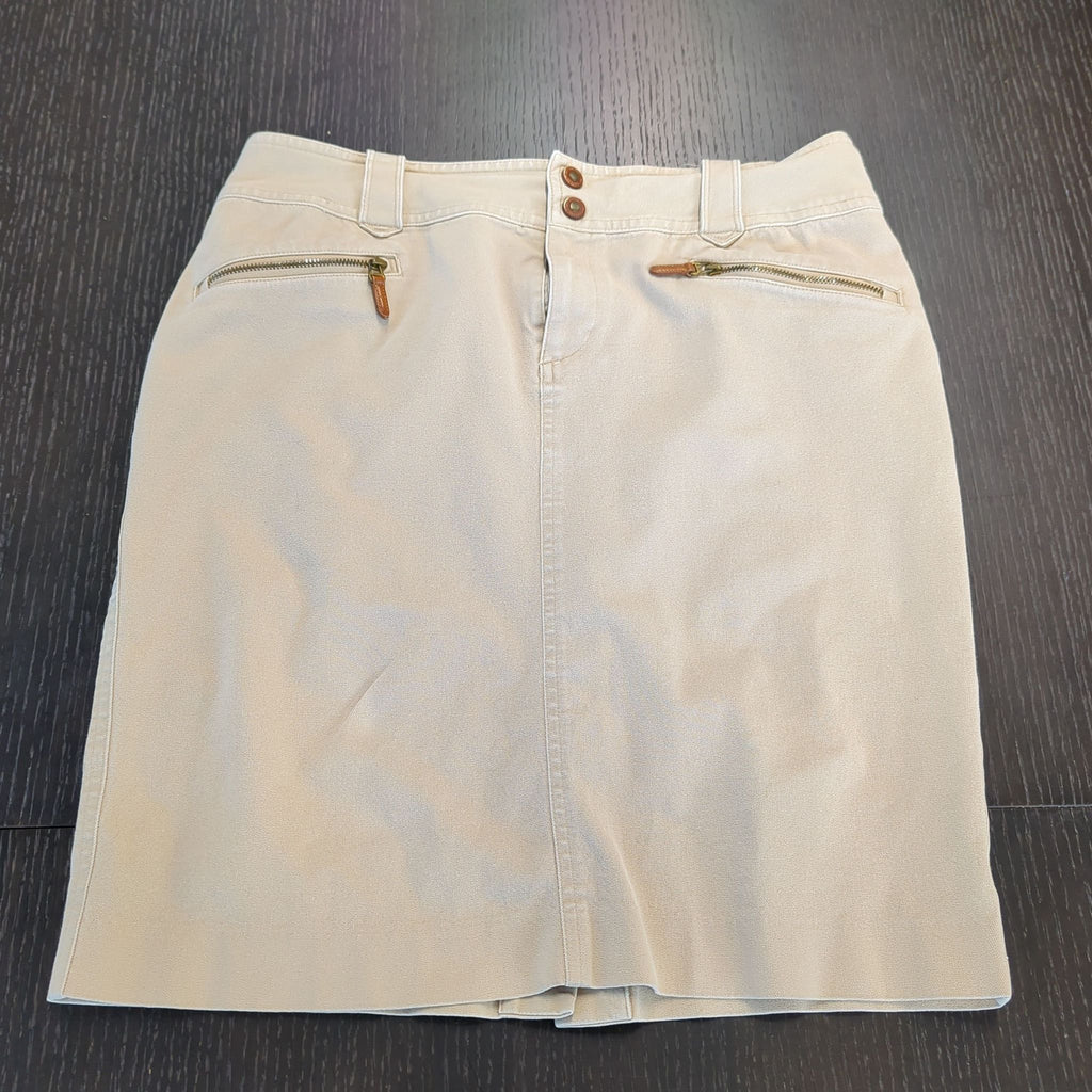 1. Beige Ralph Lauren women's skirt with front zipper pockets and double button waistband, laid flat on a dark surface.
