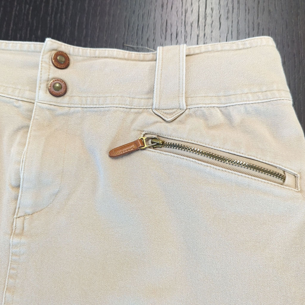 3. Detailed view of the Ralph Lauren skirt's waistband, double buttons, belt loop, and zippered pocket with leather pull.