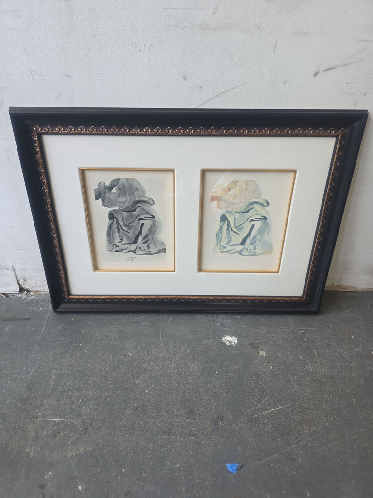 2. Double-matted framed art of robed figures in monochrome and color, leaning against a textured wall.