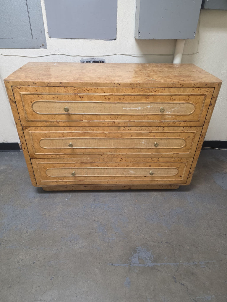 Contemporary dresser with three raffia-wrapped drawers, burl wood top, and elegant gold-tone pulls by Made Goods.