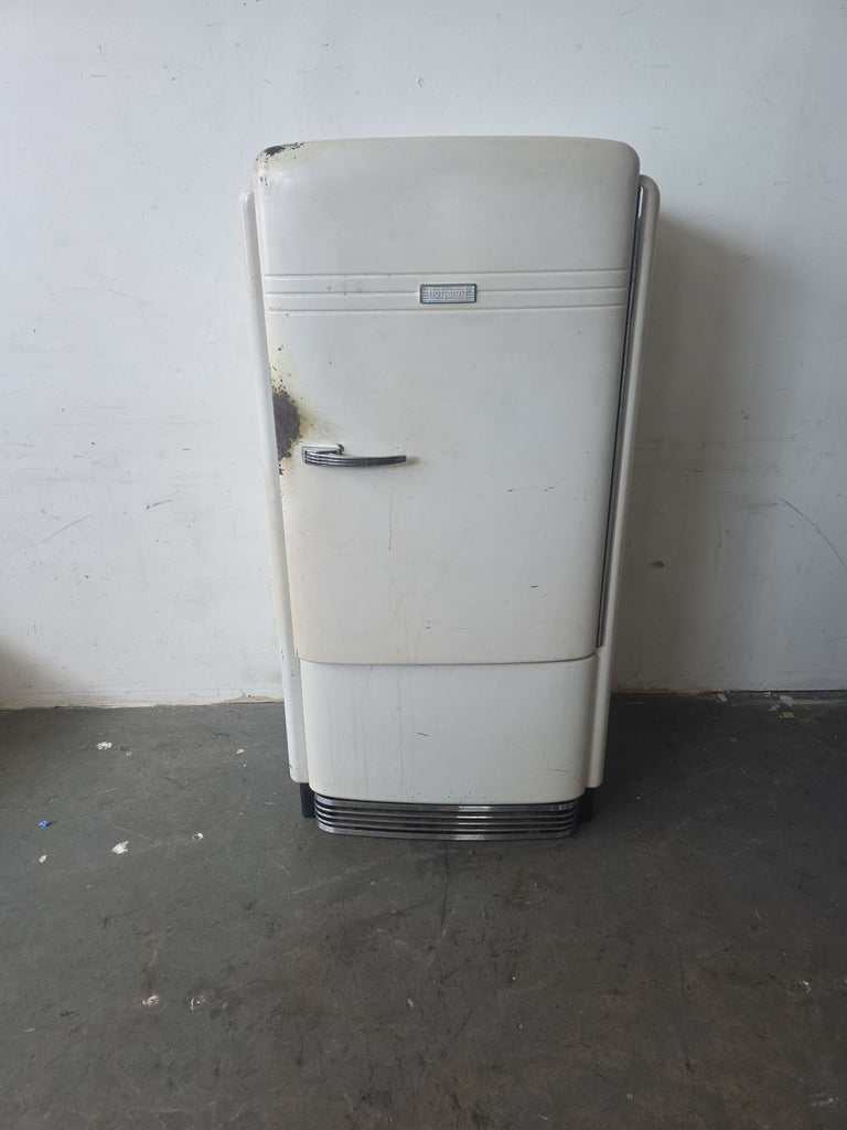 Vintage 1930s Hotpoint refrigerator with visible exterior wear, showing rust and marks, ideal for restoration.