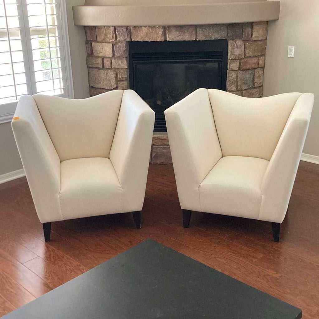 Set of two Shabby Chic lounge armchairs with cream upholstery and wooden legs, perfect for modern living rooms.